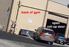 San Mateo Gymnastics back of gym, corner, and open roll-up door